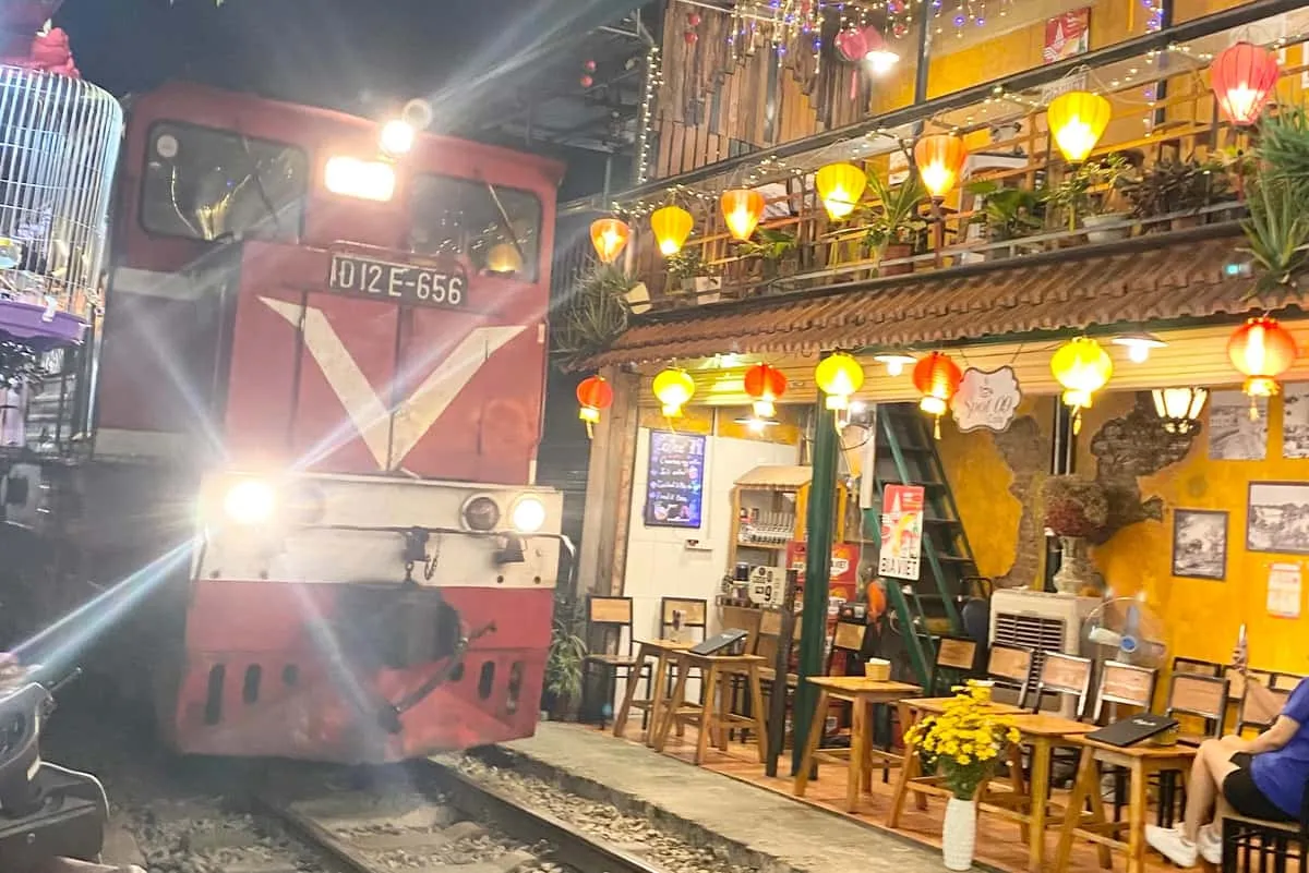 Cafe tables along the railway tracks on the Train Street stop of a hanoi food tour in Vietnam
