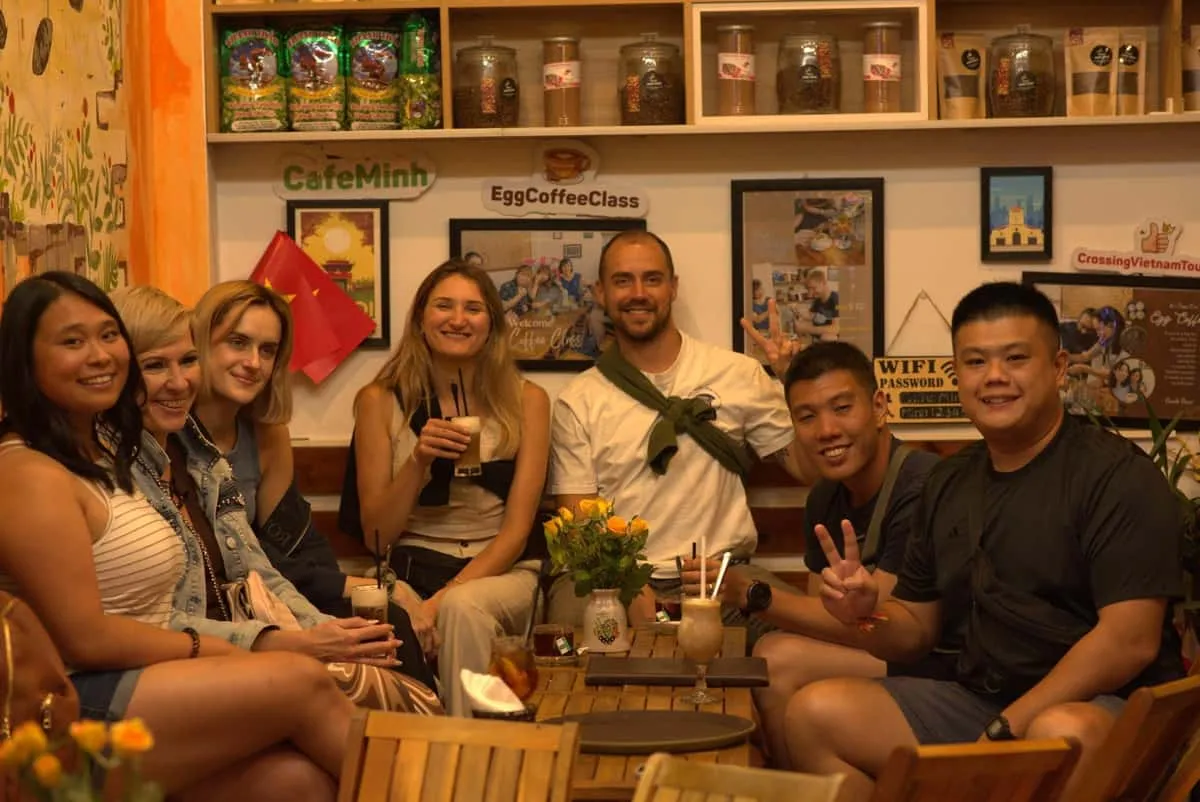 Small group tasting street snacks with a guide on a budget hanoi food tour in the Old Quarter, Vietnam